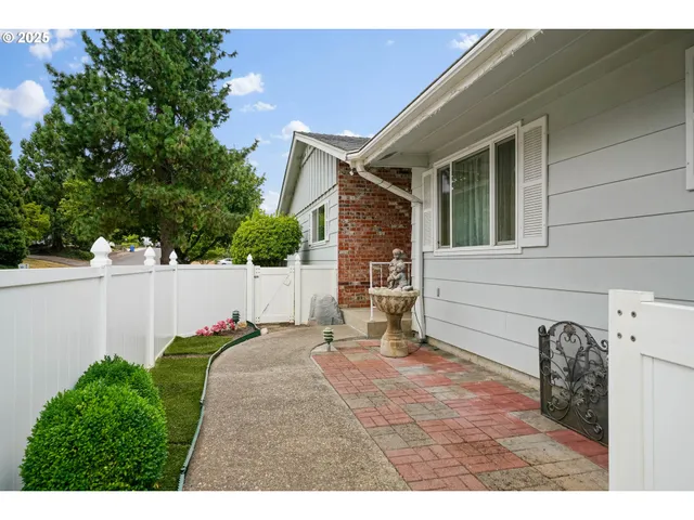 a backyard of a house with table and chairs