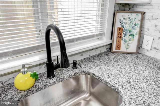 a close view of a faucet a sink and a window