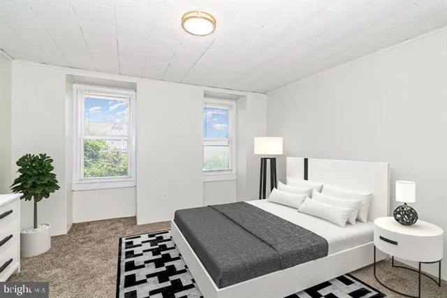 a bedroom with a bed and a potted plant