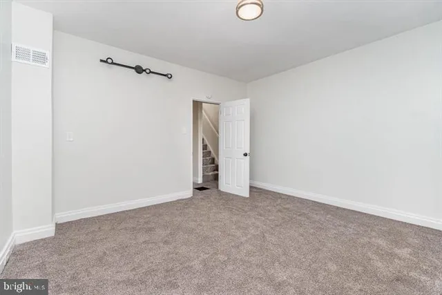 a view of an empty room with windows