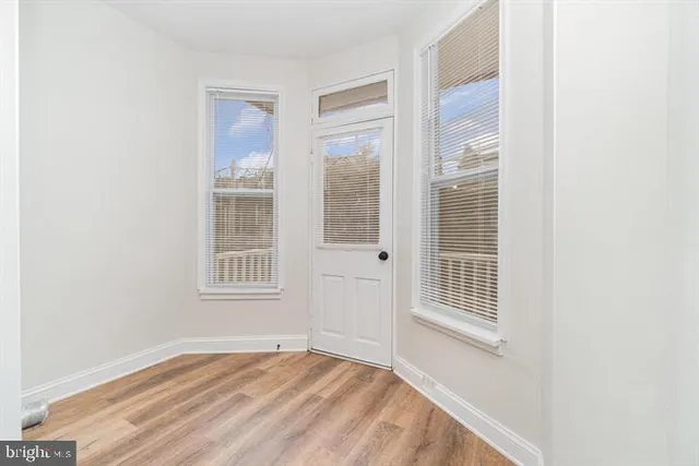 a view of a room with wooden floor and gym equipment