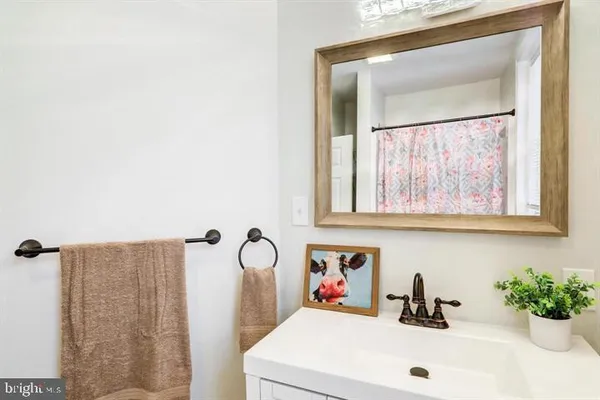 a bathroom with a sink toilet and mirror