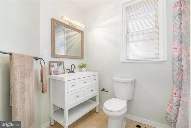a view of a hallway with wooden cabinets