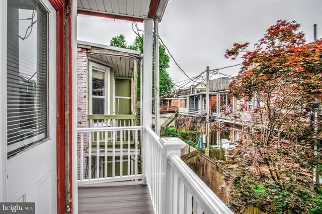 a view of a house with a door and wooden walls