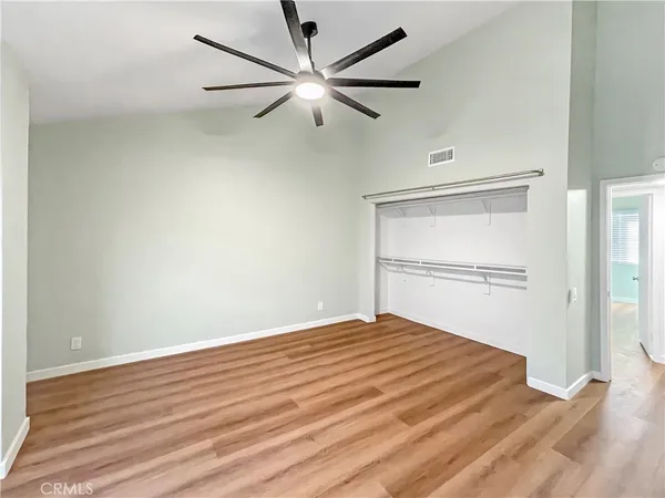 a view of empty room with wooden floor
