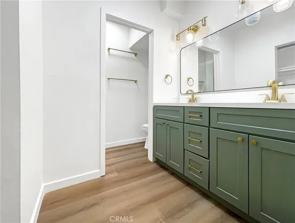 a spacious bathroom with a sink and mirror