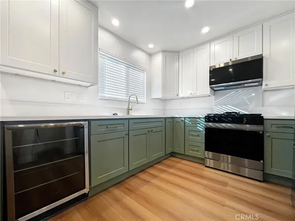 a kitchen with stainless steel appliances a stove sink and microwave