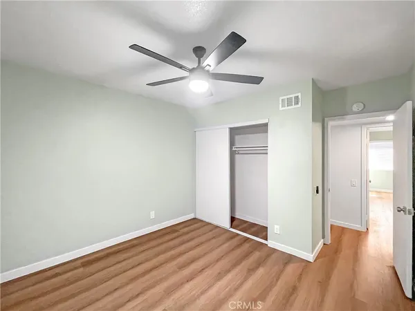 a view of empty room with wooden floor