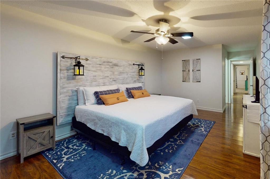 900 Westview Street Bryan, TX 77802 - Photo 15 of 30 a bedroom with a bed and wooden floor