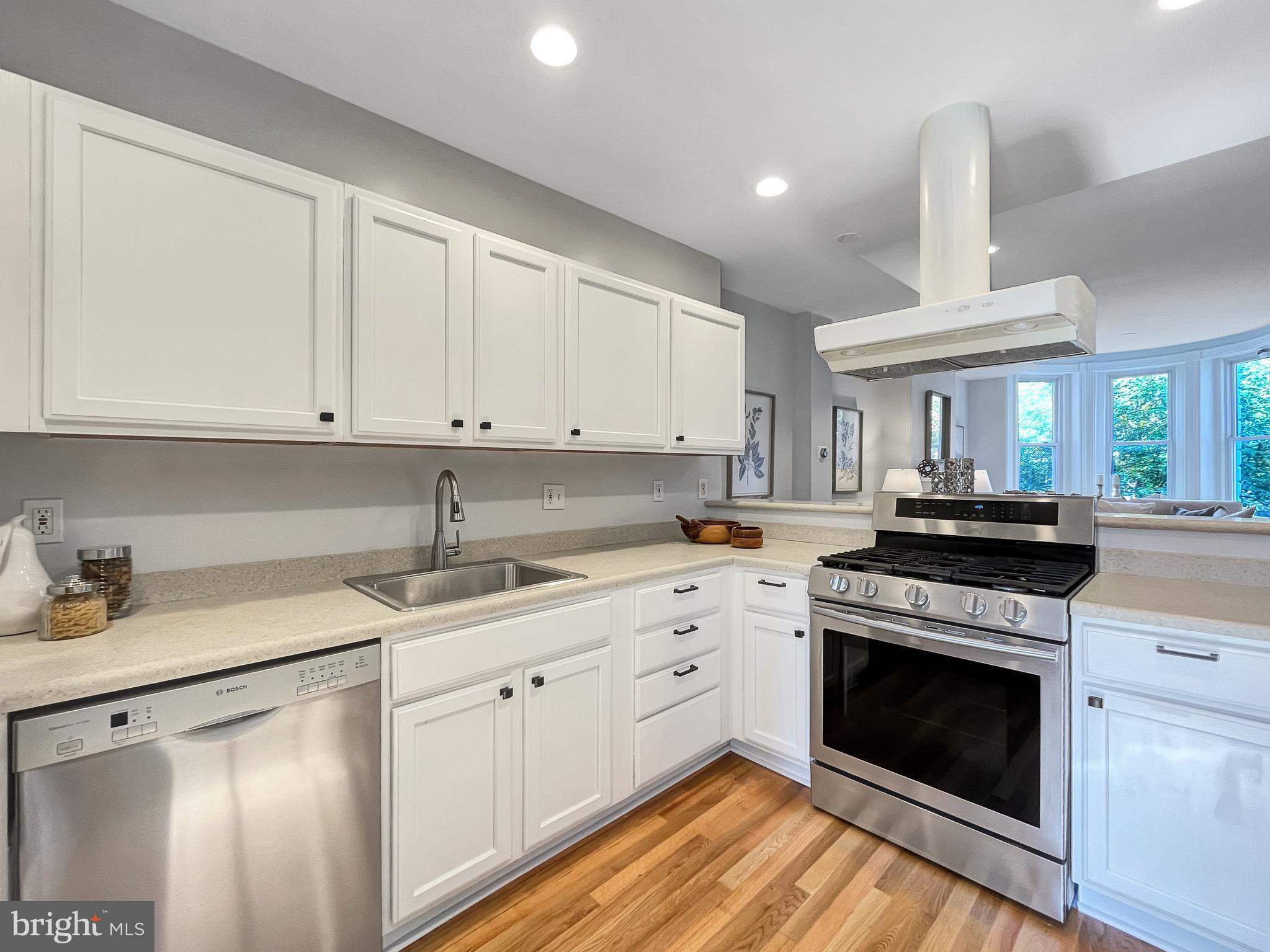 56 R Street Northwest Washington, DC 20001 - Photo 10 of 64 White kitchen features stainless appliances