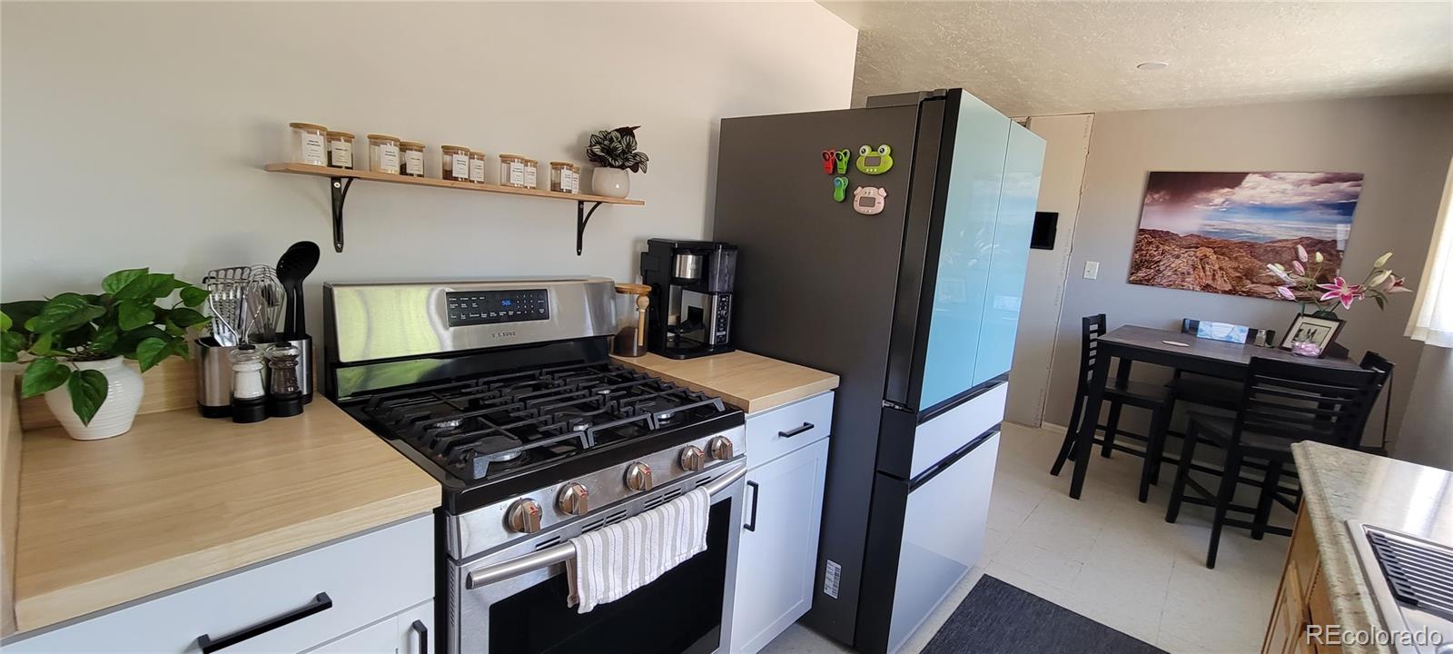 8246 Manitou Springs Road Blanca, CO 81123 - Photo 11 of 43 a kitchen with stainless steel appliances granite countertop a refrigerator and a stove