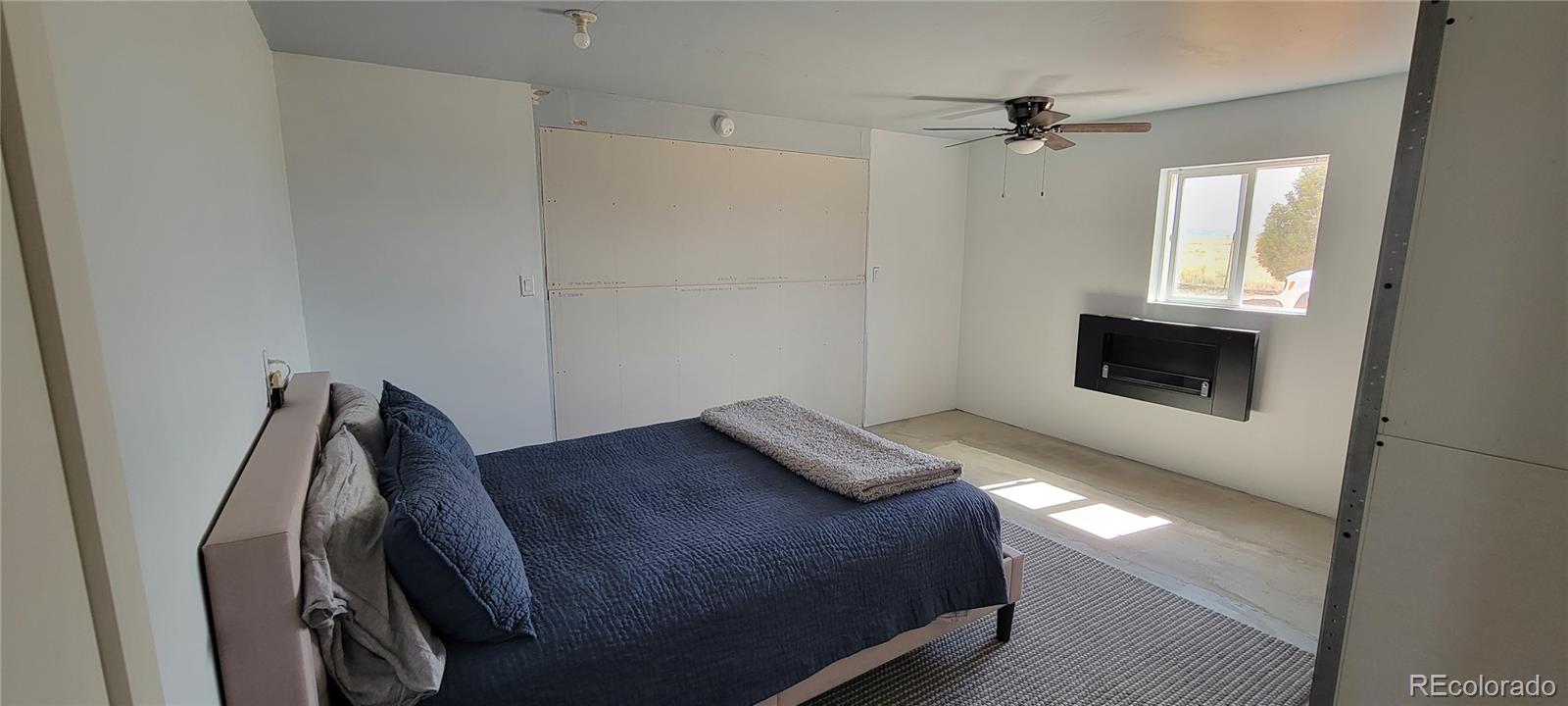 8246 Manitou Springs Road Blanca, CO 81123 - Photo 13 of 43 a bedroom with a bed and a window