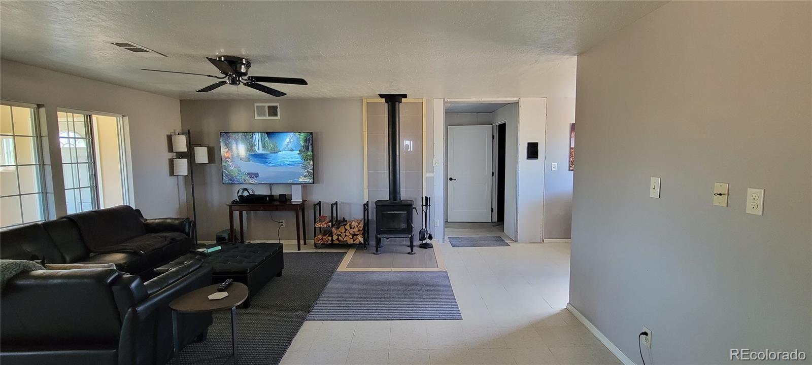 8246 Manitou Springs Road Blanca, CO 81123 - Photo 24 of 43 a living room with furniture and a flat screen tv