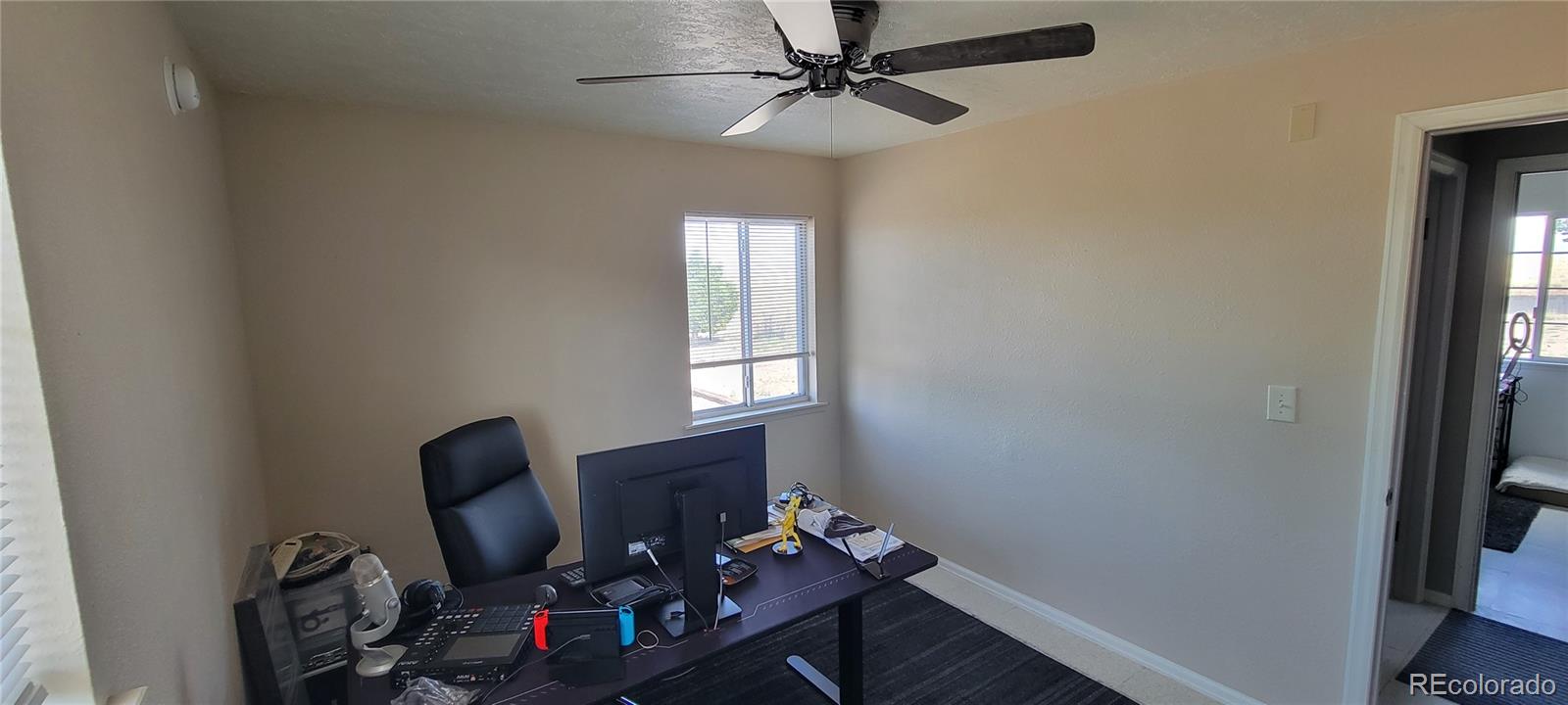 8246 Manitou Springs Road Blanca, CO 81123 - Photo 31 of 43 a view of a workspace with furniture and a window