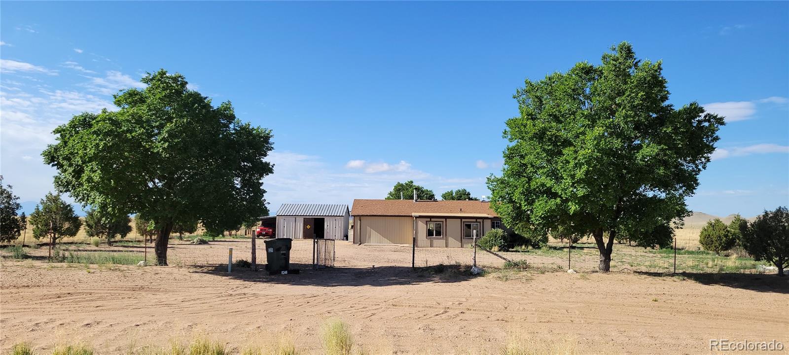 8246 Manitou Springs Road Blanca, CO 81123 - Photo 35 of 43 a view of a house with a yard