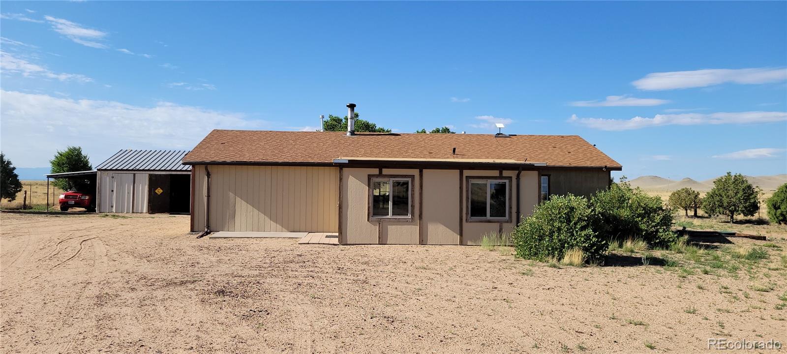 8246 Manitou Springs Road Blanca, CO 81123 - Photo 39 of 43 a view of a house with a yard