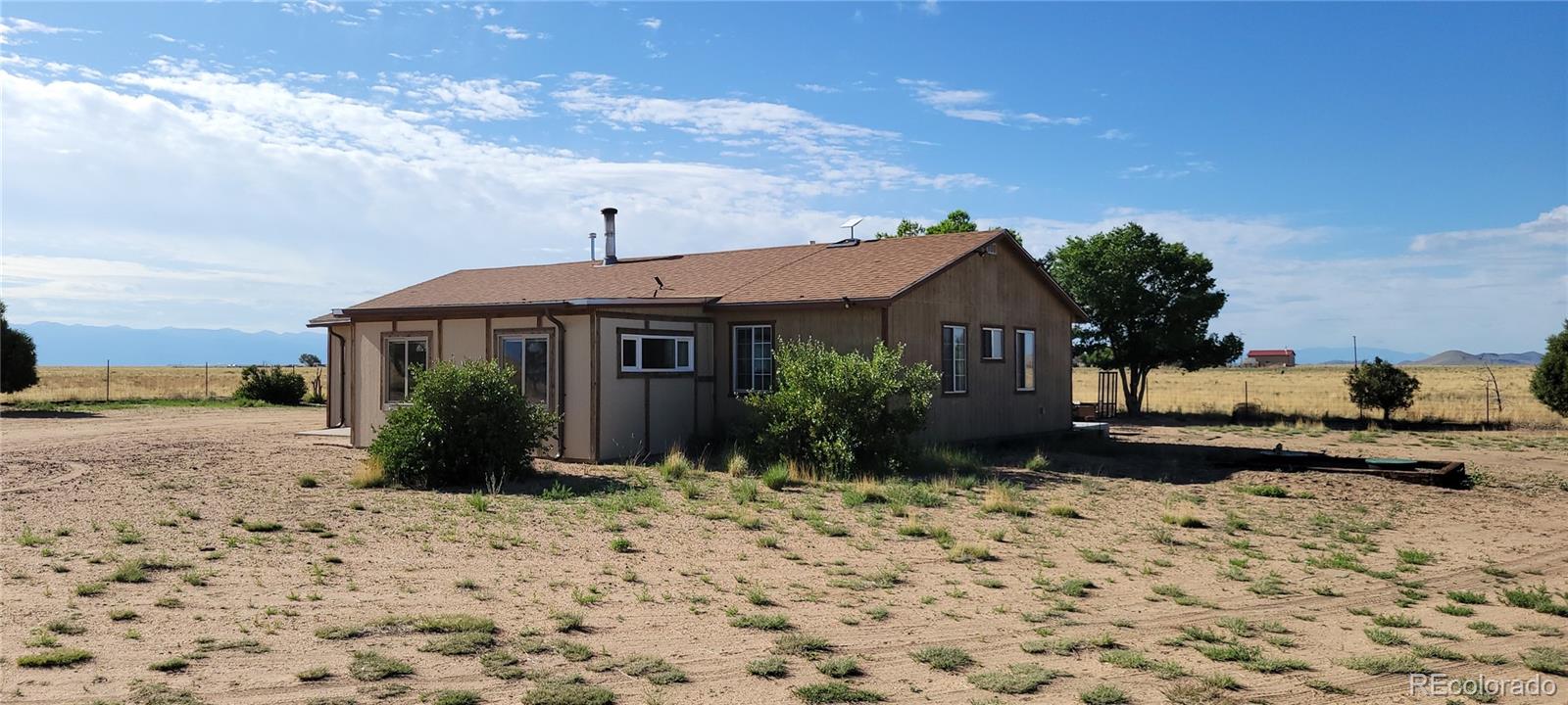 8246 Manitou Springs Road Blanca, CO 81123 - Photo 40 of 43 a front view of a house with a yard