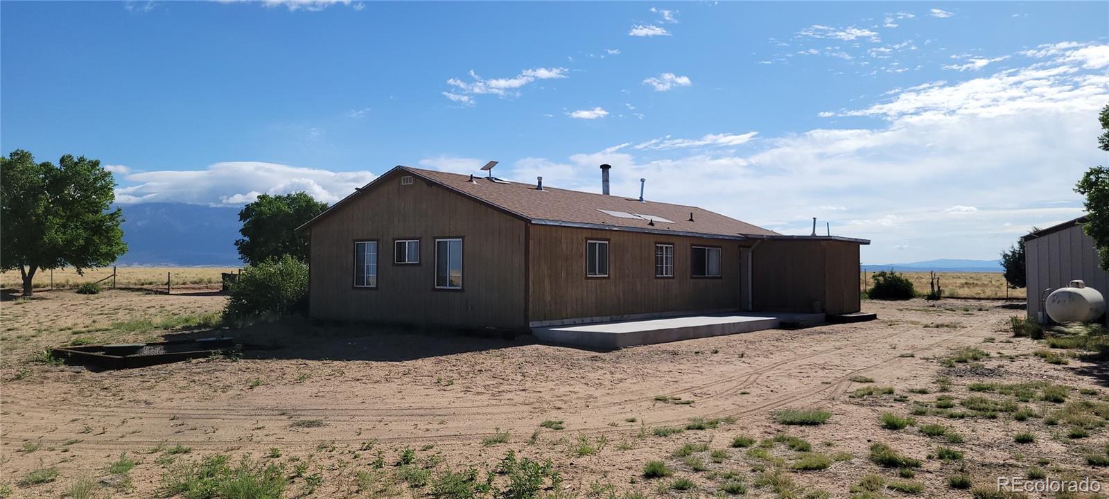 8246 Manitou Springs Road Blanca, CO 81123 - Photo 41 of 43 a front view of a house with a yard