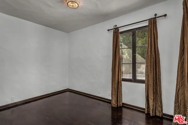 a view of an empty room and wooden floor