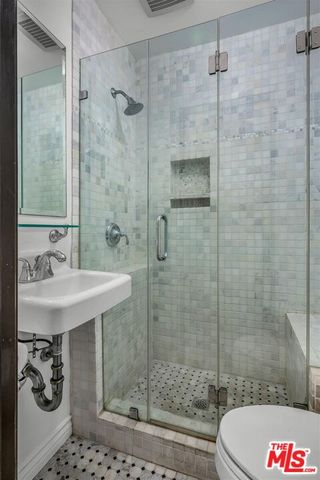 a bathroom with a shower and a sink