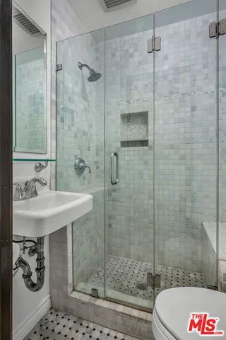 a bathroom with a shower and a sink