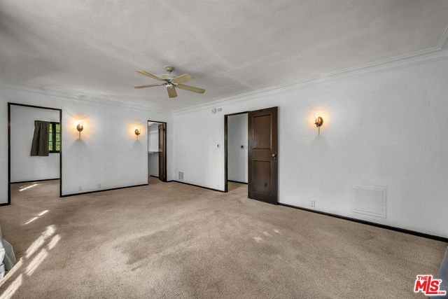 an empty room with closet and windows