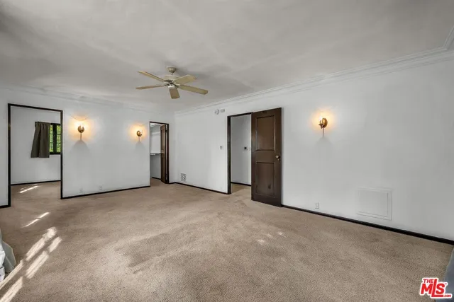 an empty room with closet and windows