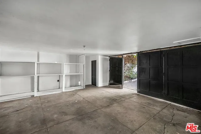 a bathroom with a sink shower and a mirror