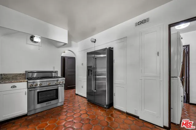a kitchen with a stove and a refrigerator