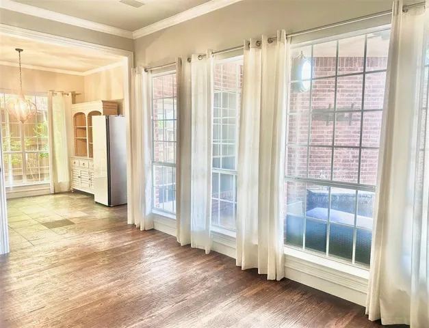 a living room with a fireplace and wooden floor