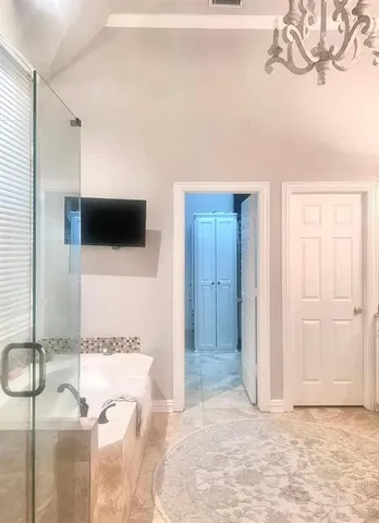 a spacious bathroom with a granite countertop sink a mirror and a shower