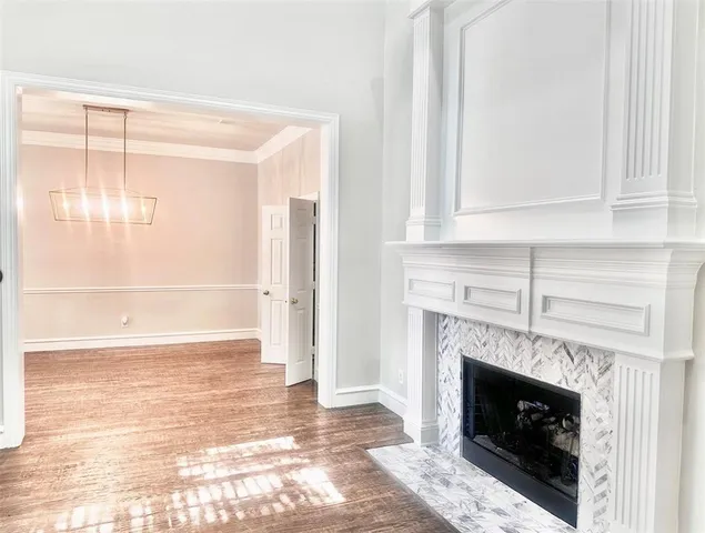 a view of an empty room with fireplace and a window