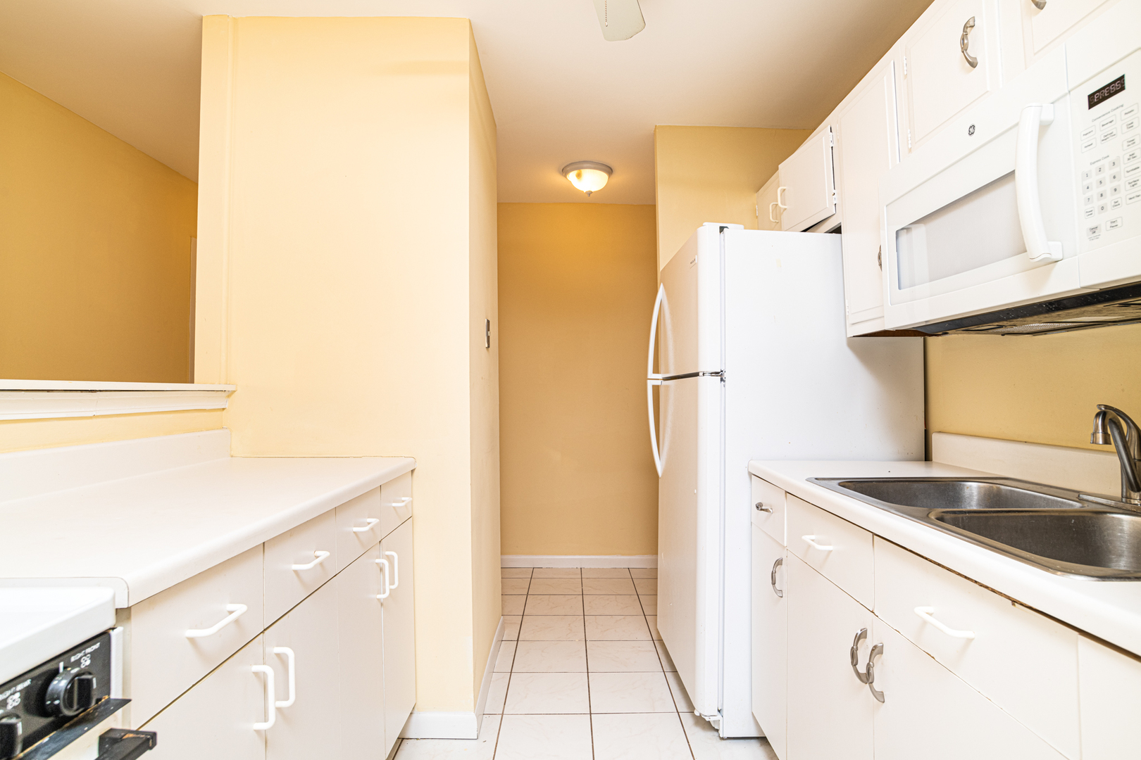 6171 North Sheridan Road, Unit 2404 Chicago, IL 60660 - Photo 6 of 16 a kitchen with a sink cabinets and refrigerator