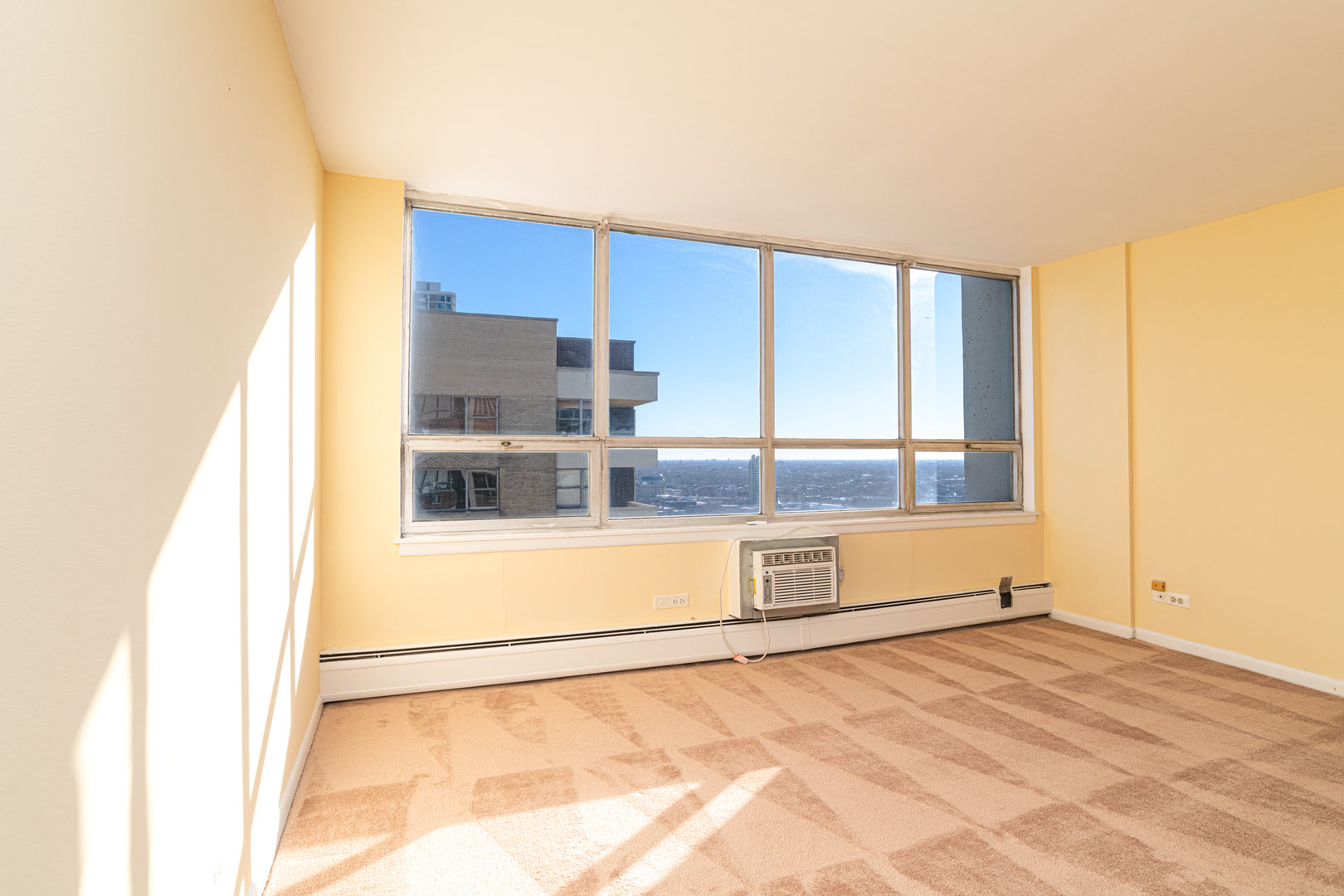 6171 North Sheridan Road, Unit 2404 Chicago, IL 60660 - Photo 9 of 16 a view of a living room with a large window