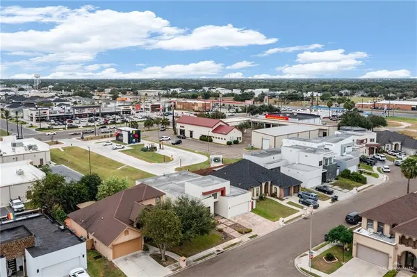 an aerial view of a house with swimming pool and lake view