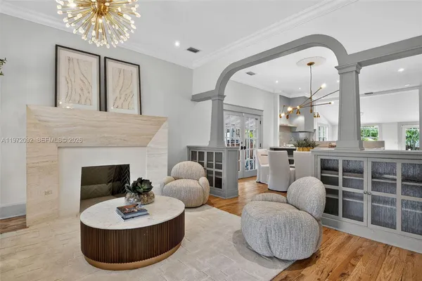 a living room with furniture a fireplace and a large window