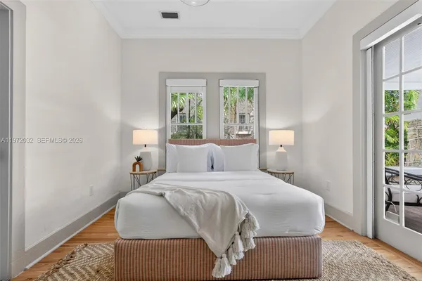 a view of a patio with a dining table and chairs with wooden fence and plants
