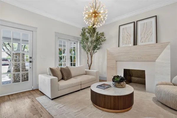 a living room with furniture fireplace and chandelier