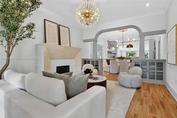 a dining room with furniture potted plants and wooden floor