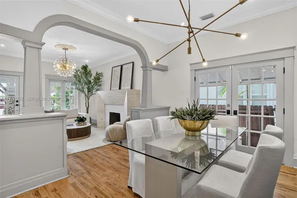 a view of a dining room with furniture and a potted plant