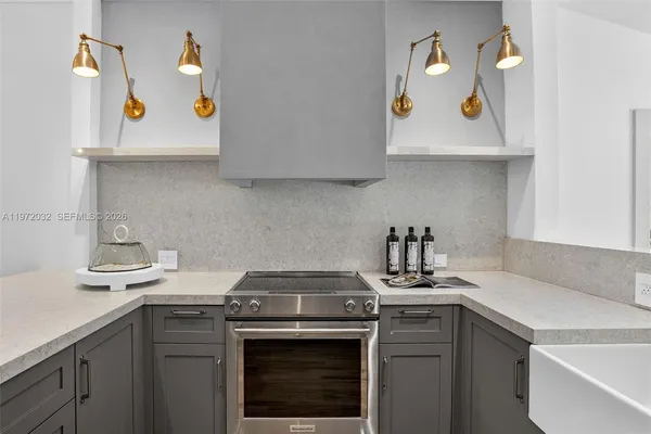 a bedroom with a large bed a chandelier and a window