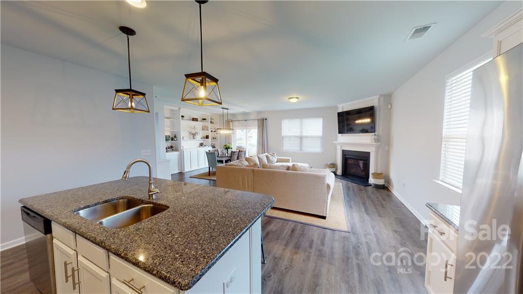 408 Accord Street Myrtle Beach, SC 29588 - Photo 13 of 43 a kitchen view with a stove a faucet a chimney and a center island