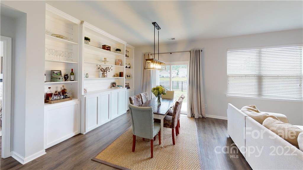 408 Accord Street Myrtle Beach, SC 29588 - Photo 19 of 43 a dining room with furniture a chandelier and wooden floor
