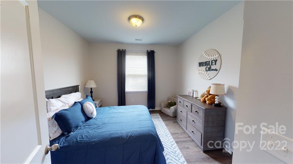 408 Accord Street Myrtle Beach, SC 29588 - Photo 26 of 43 a bed room with a bed and a chandelier