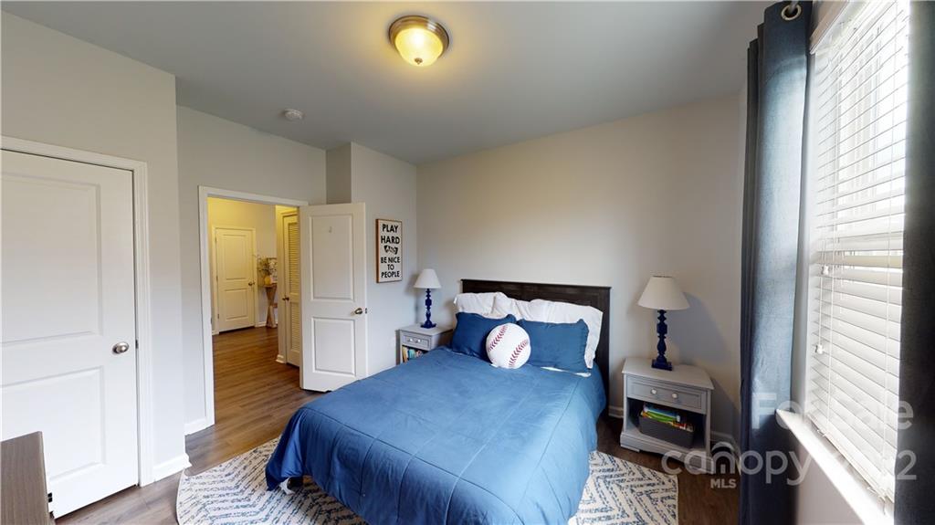 408 Accord Street Myrtle Beach, SC 29588 - Photo 27 of 43 a bedroom with a bed and wooden floor