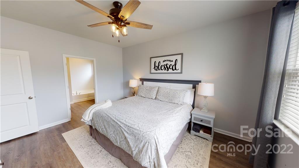 408 Accord Street Myrtle Beach, SC 29588 - Photo 31 of 43 a bedroom with a bed and a chandelier