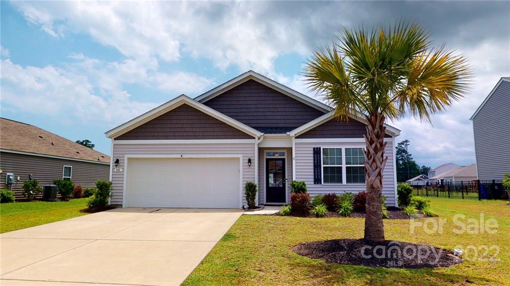 408 Accord Street Myrtle Beach, SC 29588 - Photo 40 of 43 a front view of a house with a yard garage and outdoor seating