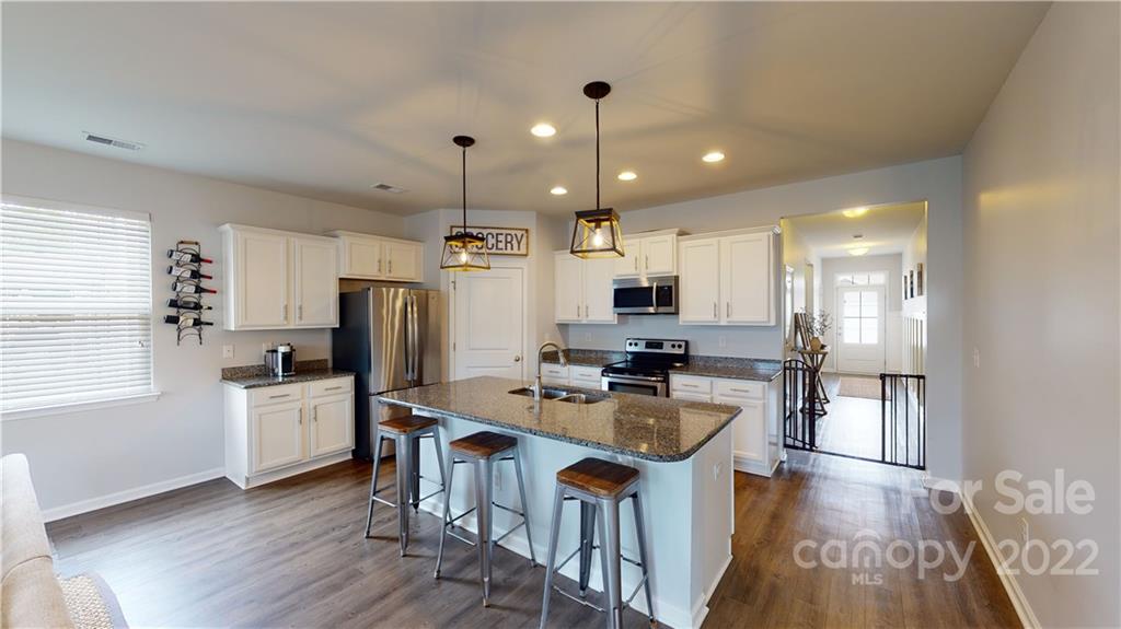 408 Accord Street Myrtle Beach, SC 29588 - Photo 8 of 43 a kitchen with refrigerator cabinets and wooden floor
