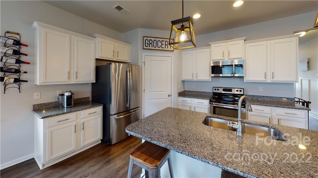 408 Accord Street Myrtle Beach, SC 29588 - Photo 9 of 43 a kitchen with stainless steel appliances granite countertop a sink stove and refrigerator