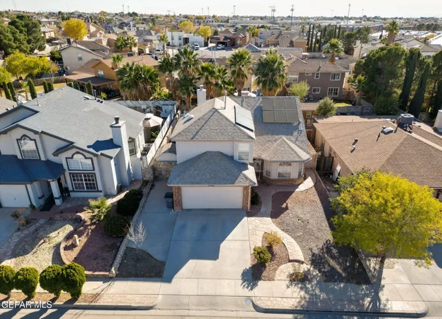 an aerial view of a house with lots of mountains in the background